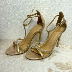 Gold heels about 4” tall. Adjustable strap